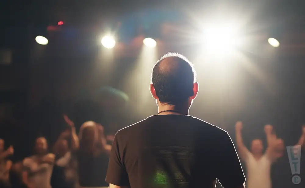 a rear view picture of musician dafnis prieto performing on stage