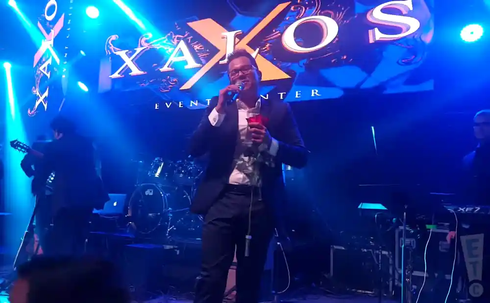 charlie zaa performing on stage under blue lights