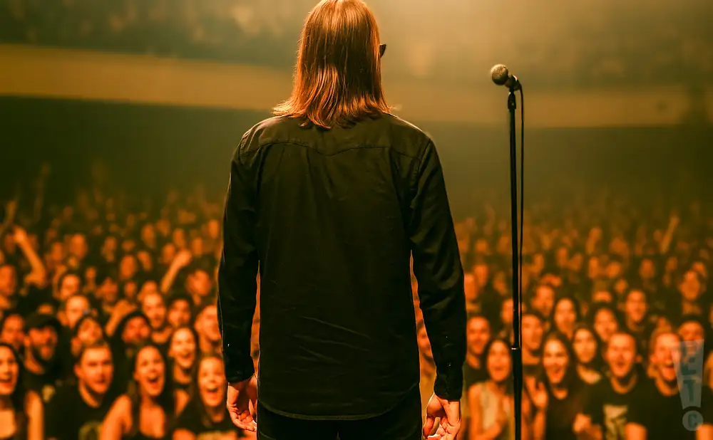 a rear view photo of american nightmare performing a concert on stage to a lively audience