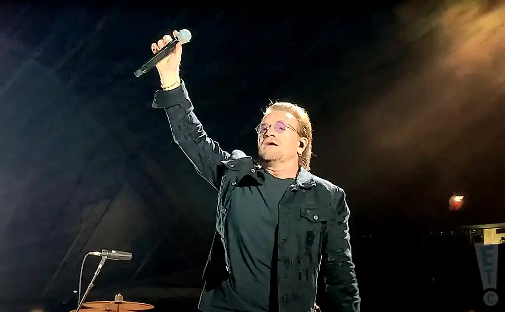 bono performing on stage at the national stadium in kallang singapore