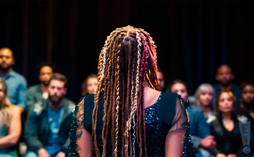 a rear view photo of debby holiday performing a concert on stage to a lively audience
