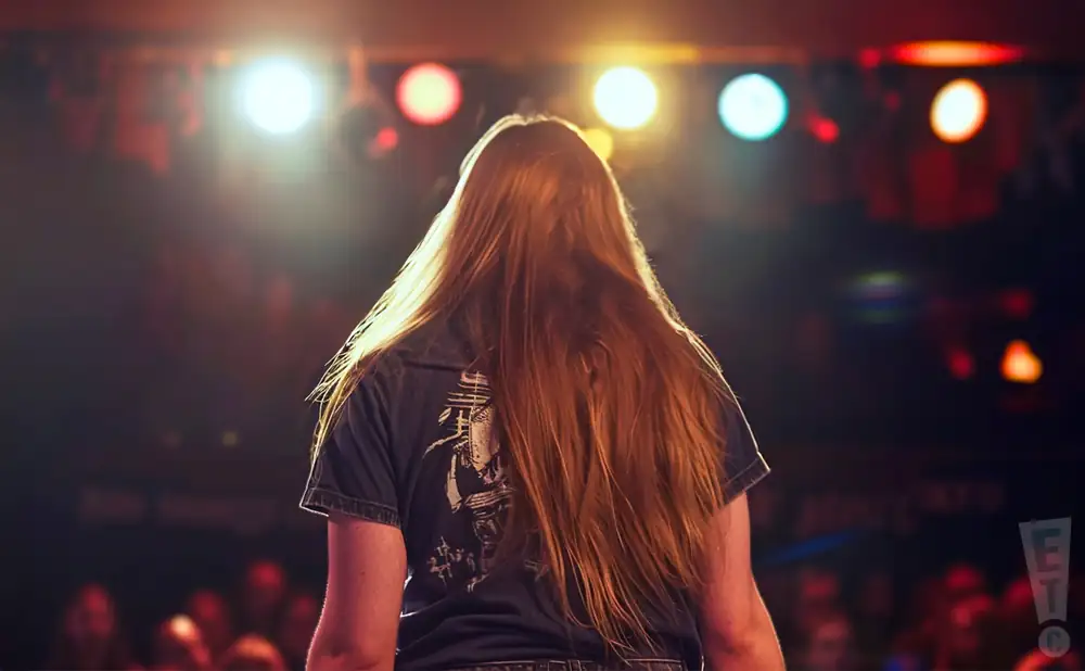 a photograph from behind cannon dunwoody of the band garst performing on stage in front of a large audience