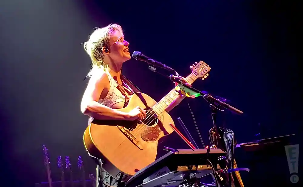 meg myers playing the guitar and singing on stage