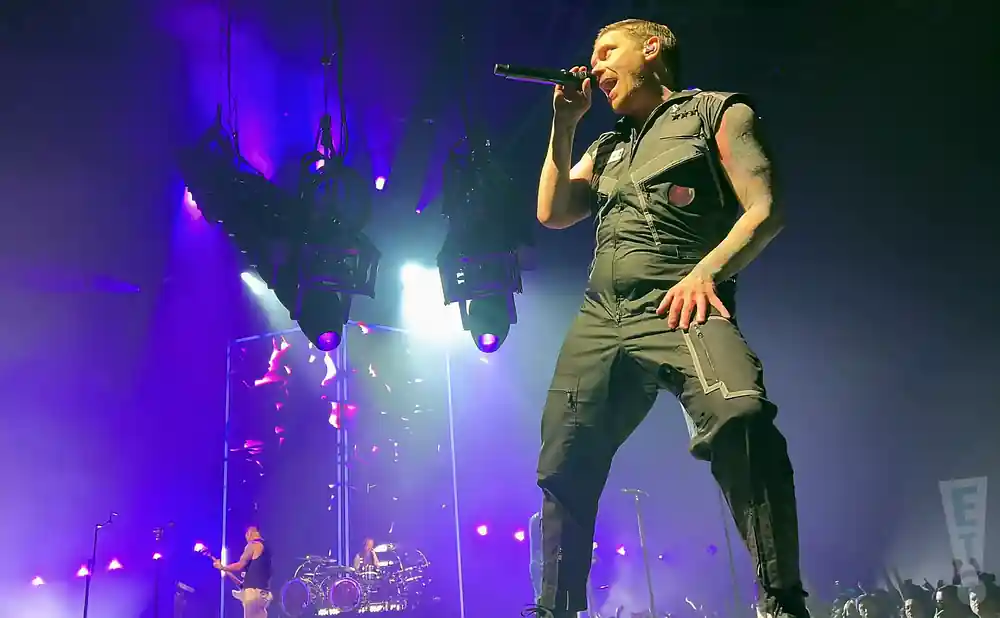 shinedown lead singer performing on stage