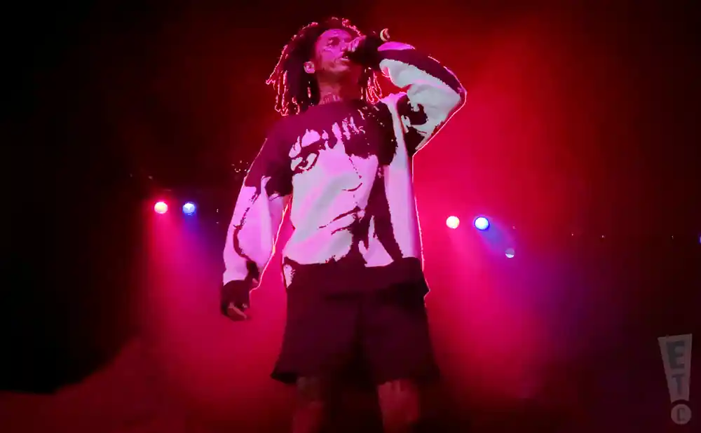 city morgue member rapping on stage in front of red lights