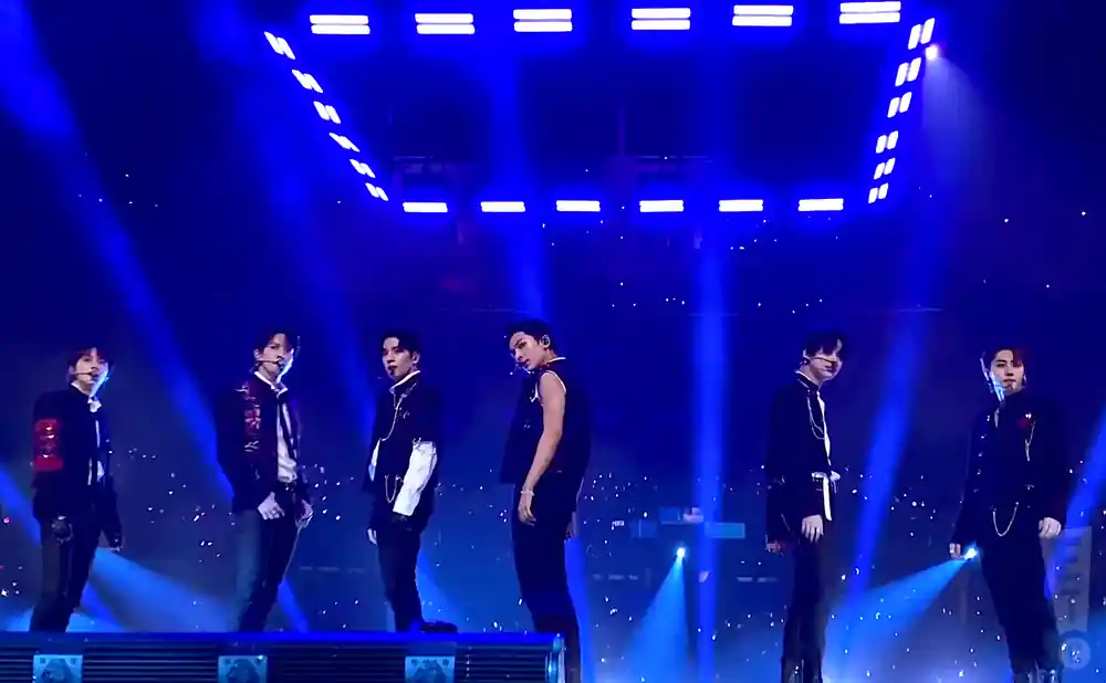 pass the mic performing on stage, shot of whole group.