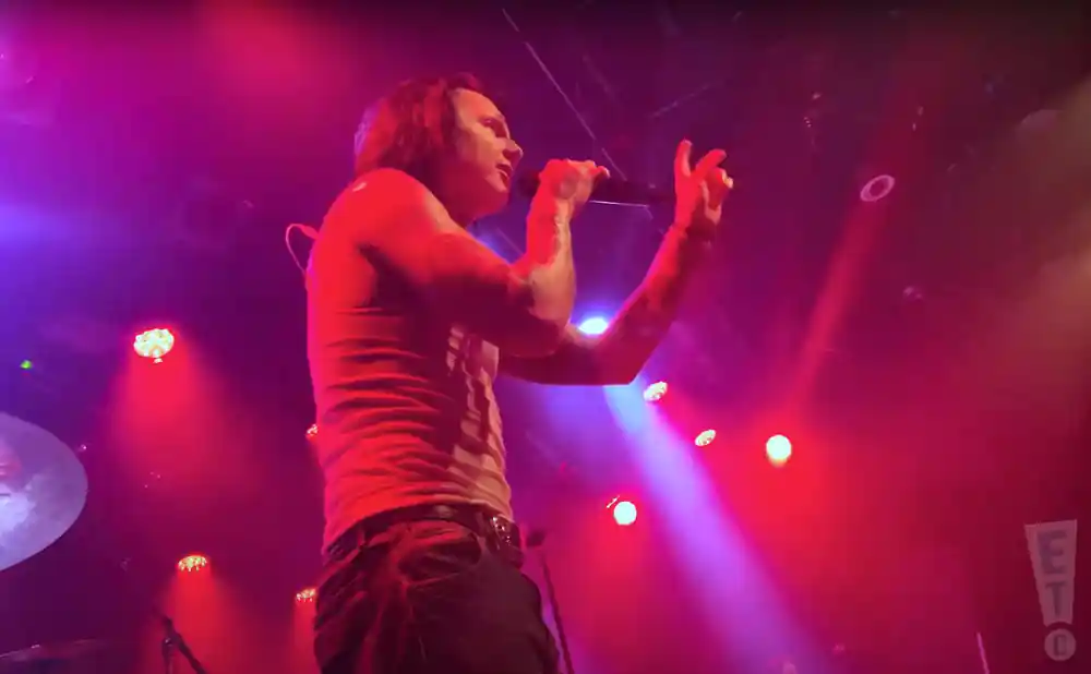 sueco the child rapping on stage under red lights