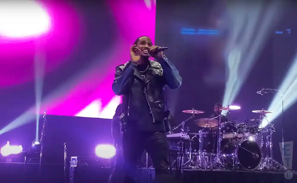trey songz rapping on stage in a leather jacket