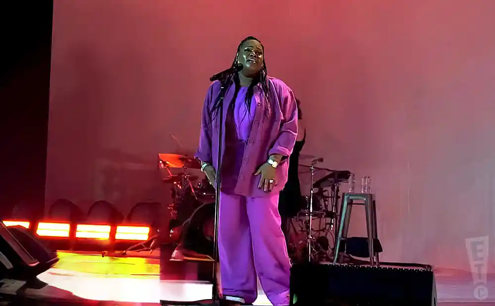 tasha cobbs leonard performing in a pink jacket at the james l knight center in miami florida