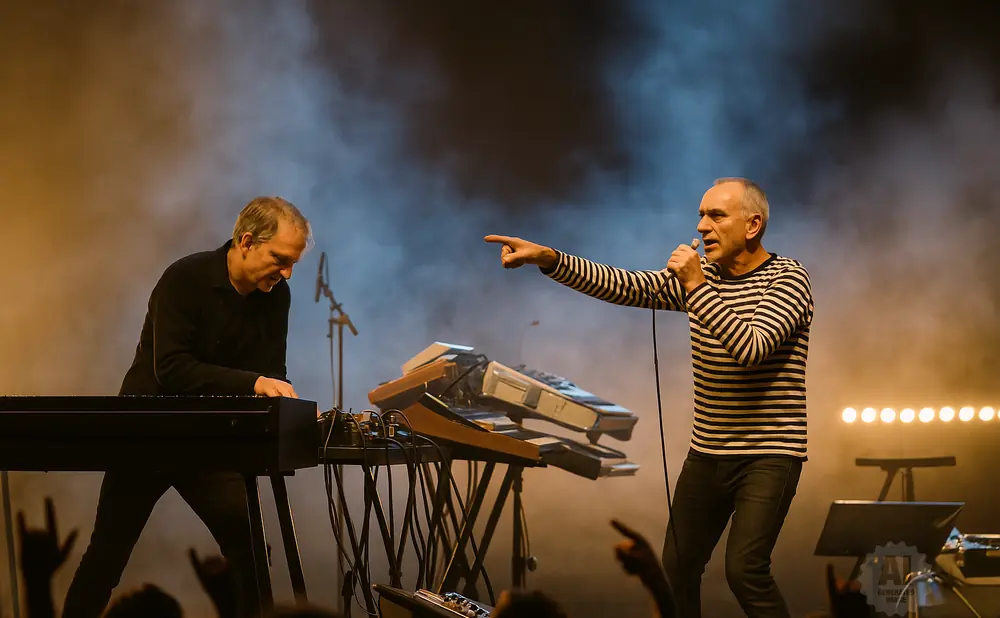 Singer points to keyboardist during a live performance.