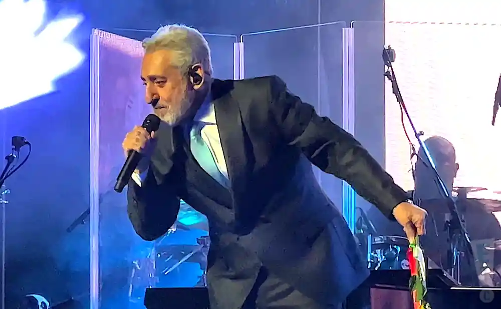 ebi performing on stage in a suit