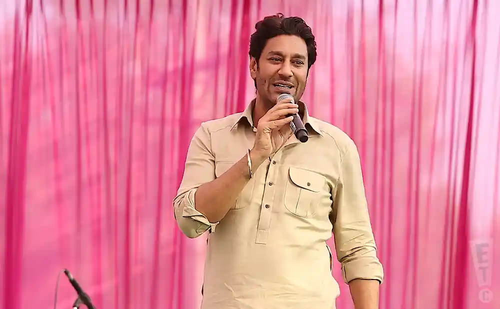 harbhajan mann singing on stage in front of pink backdrop