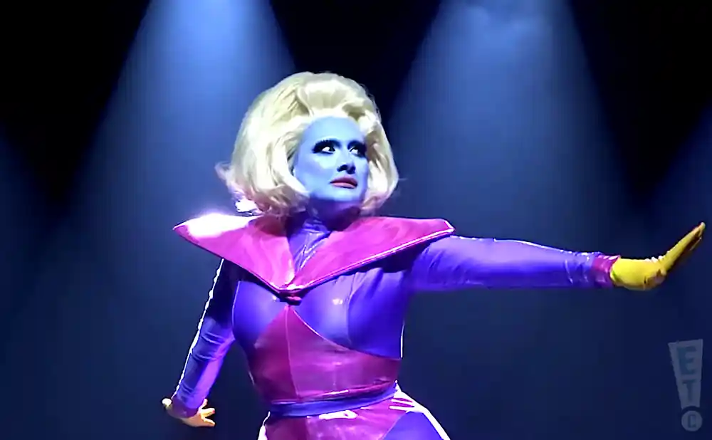 juno birch performing in purple and yellow outfit.