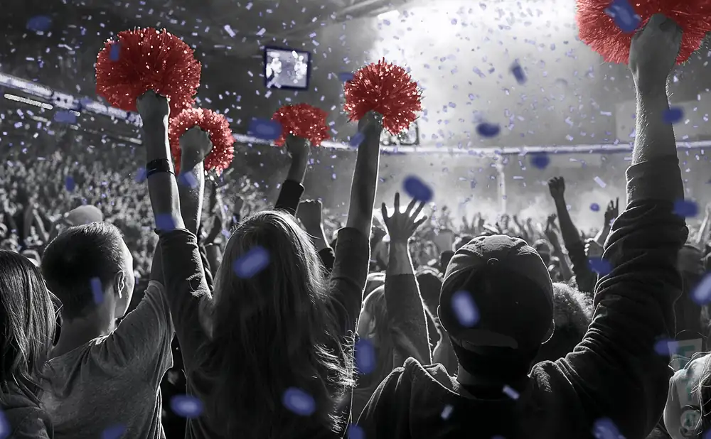 a crowd of belmont bruins fans cheering for their team
