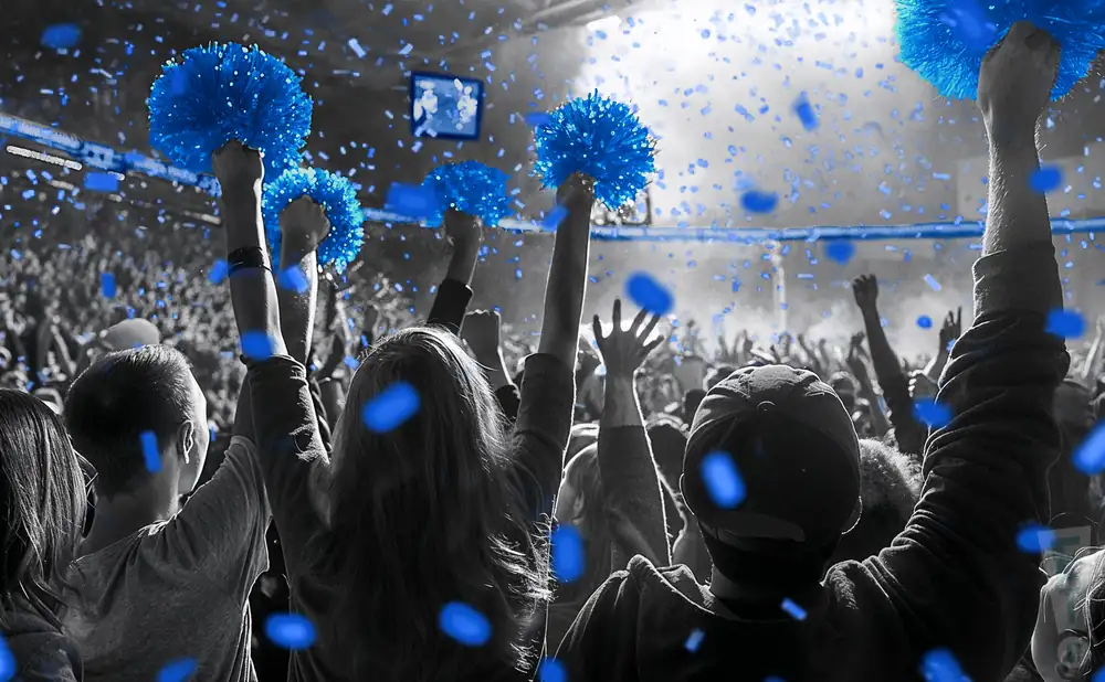 a picture of an indiana state sycamores fan cheering at his team from the stands 