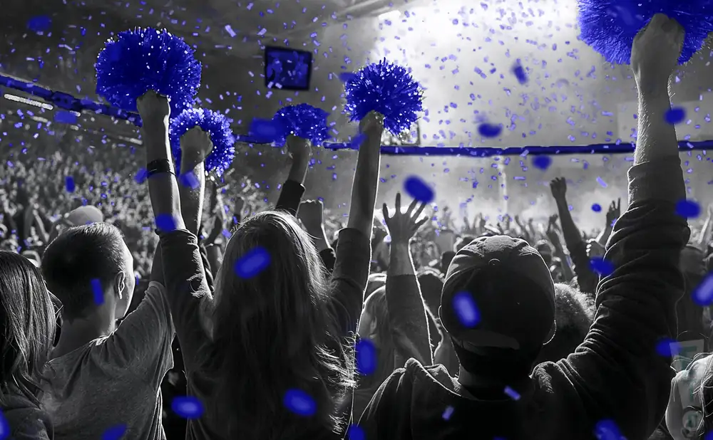 a crowd of nevada wolf pack fans cheering for their basketball team