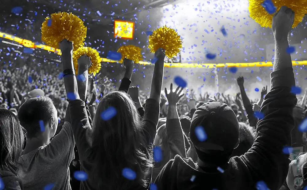 a crowd of north carolina a&t aggies fans cheering for their basketball team