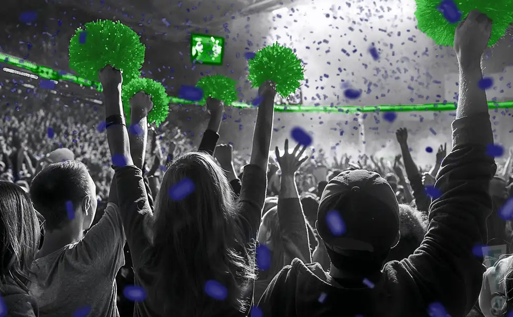 a crowd of unt dallas trailblazer fans cheering for their basketball team