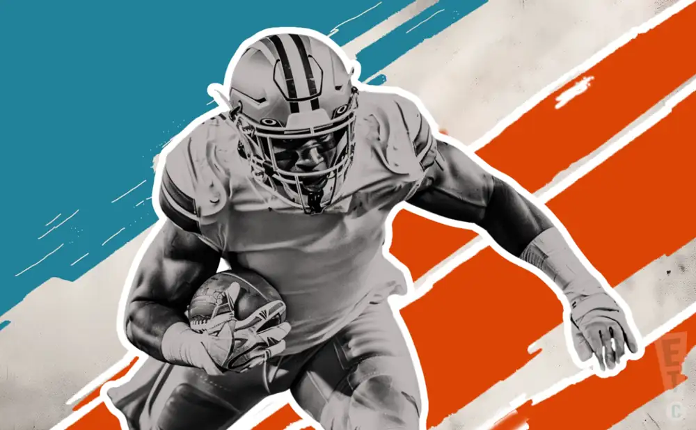 a miami dolphins football player runs with the ball