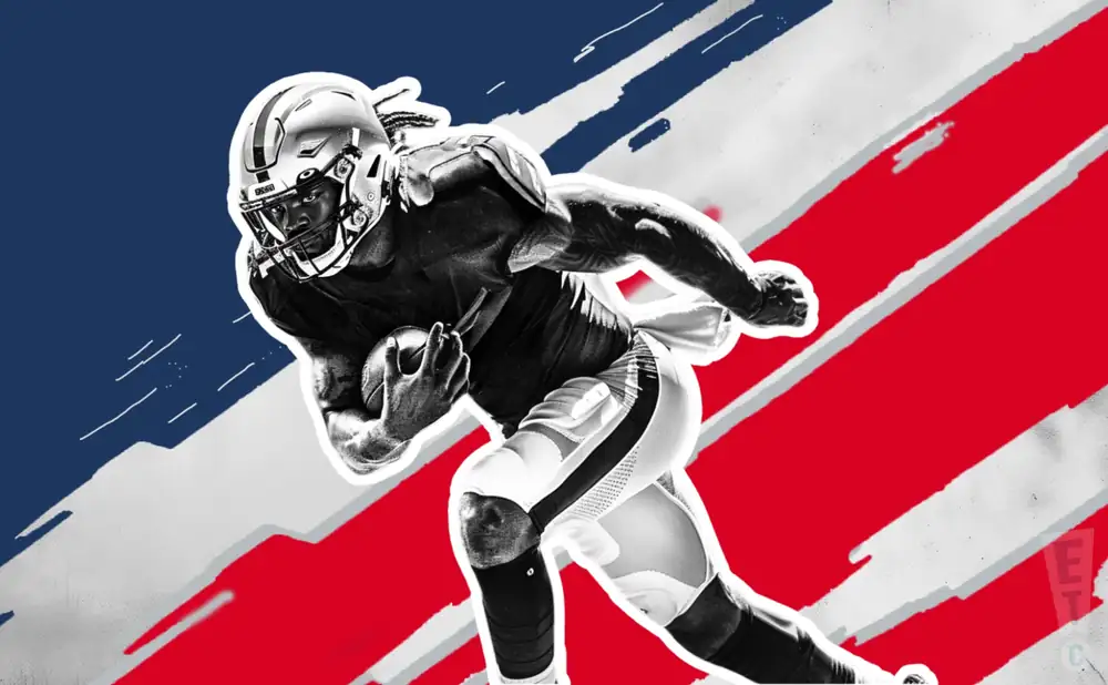 a new england patriots football player runs with the ball