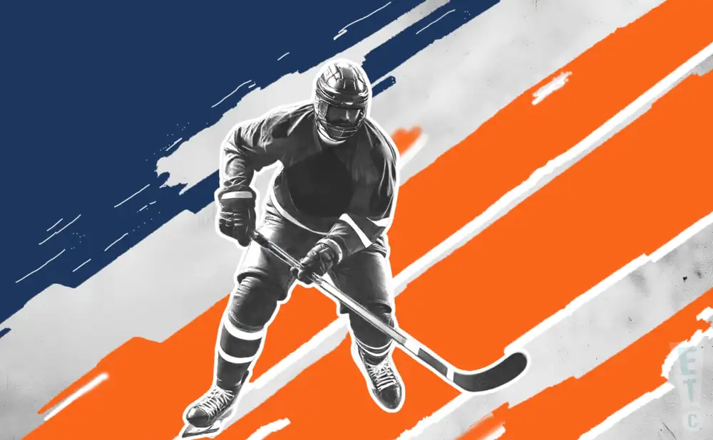 an edmonton oilers hockey player about to hit the puck