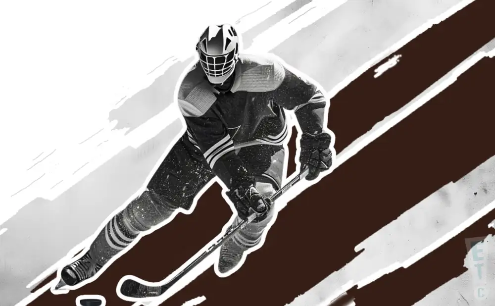 a kenai river brown bears ice hockey player about to hit the puck