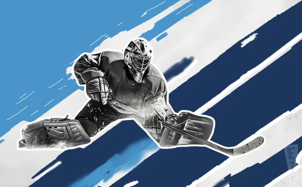 a new hampshire mountain kings ice hockey player about to hit the puck