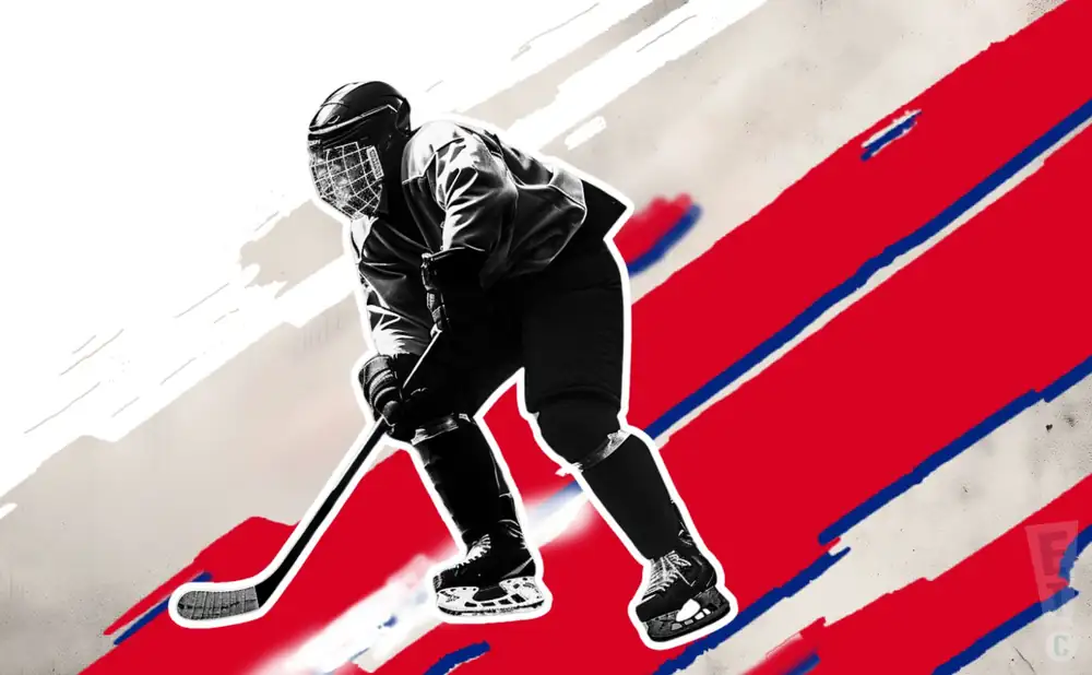 a rochester jr. americans ice hockey player about to hit the puck