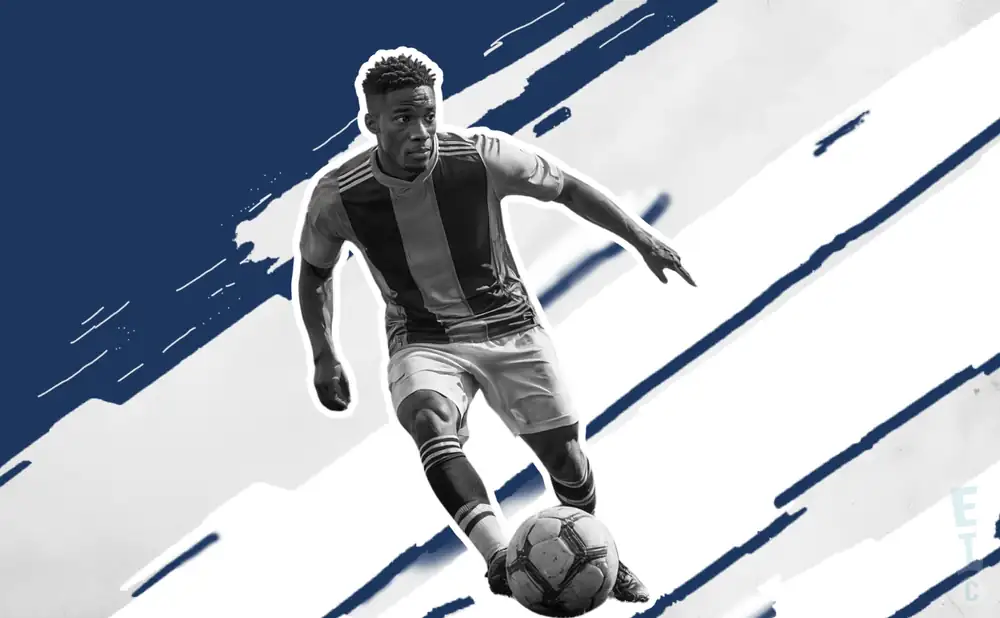 a cf monterrey soccer player kicking the ball down field