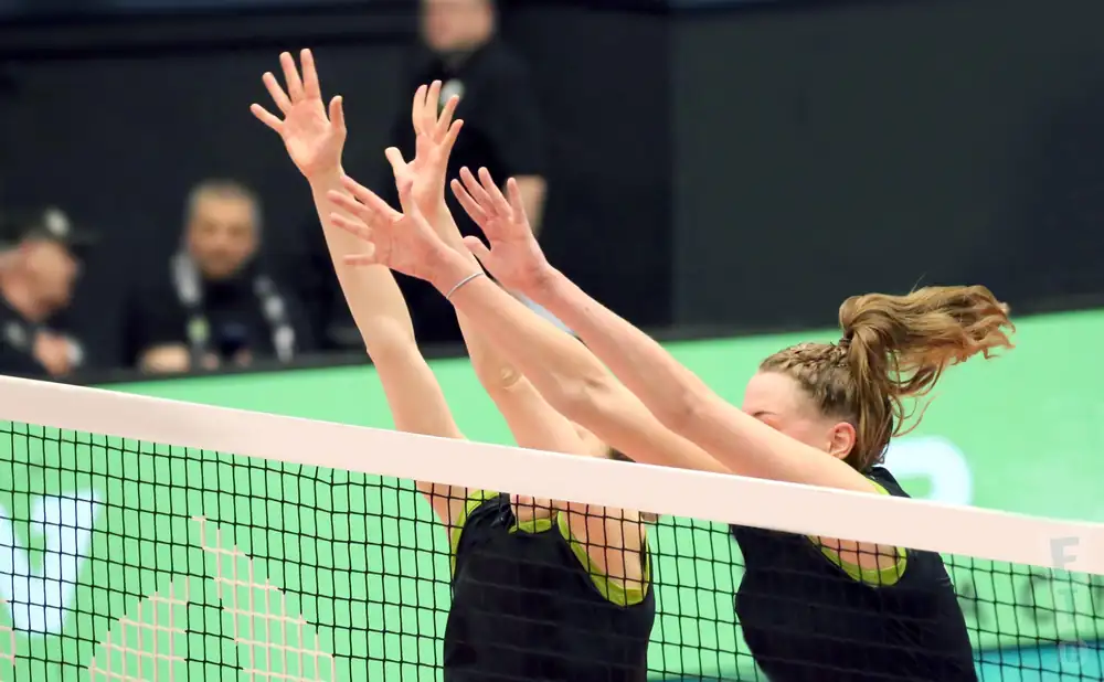 a professional female volleyball player in mid action at a match at the ncaa women's volleyball tournament 