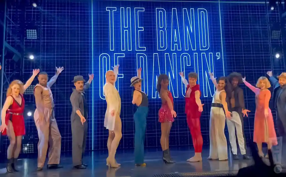 dancers in the bob fosse's dancin' show posing together.