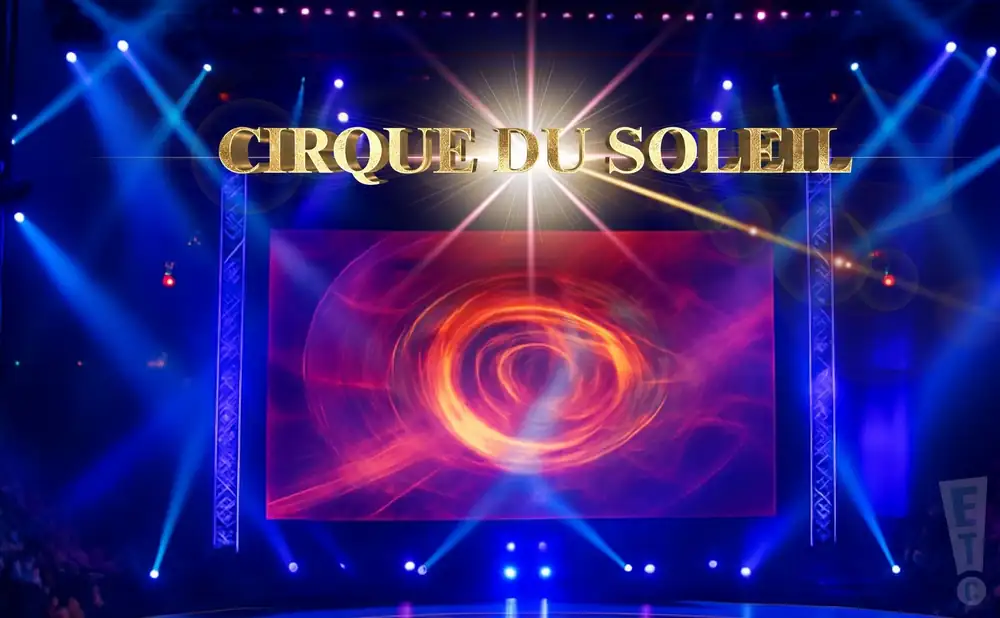 cirque du soleil - o acrobat performs aerial acrobatics above the audience.