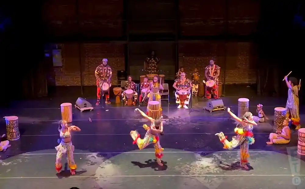 dancers and musicians preforming on stage in danceafrica show.