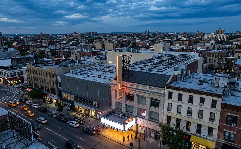 An aerial view of the Apollo Theater in Harlem, New York City, at dusk.