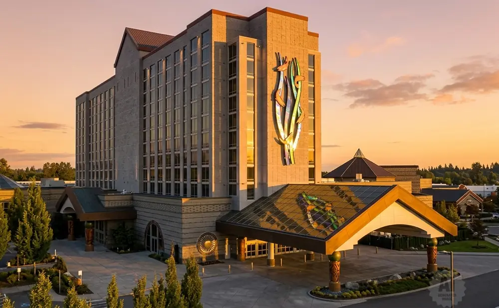 A hotel at sunset with ornate architecture and a large colorful art installation on the facade.