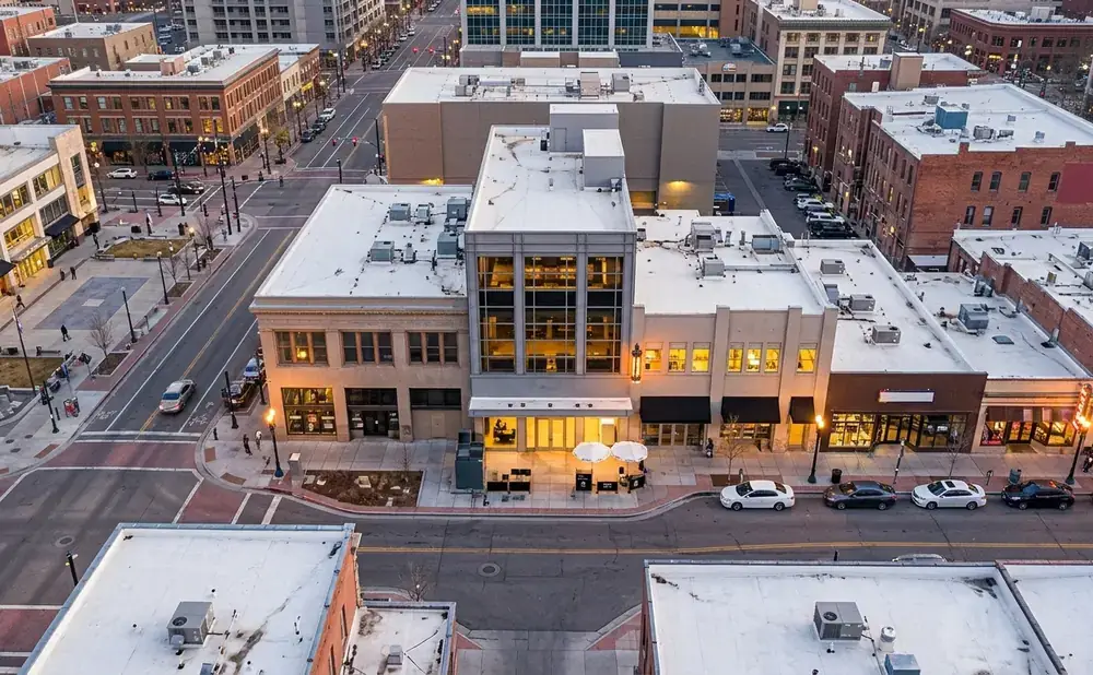 Aerial view of a city street with brick buildings and modern architecture.