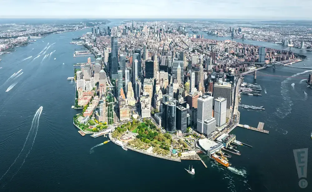 Aerial view of the Manhattan skyline with boats on the water.