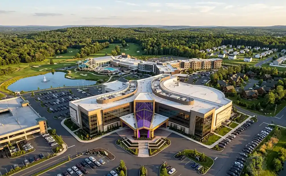 Aerial view of a large resort complex with a golf course, water park, and parking lots.