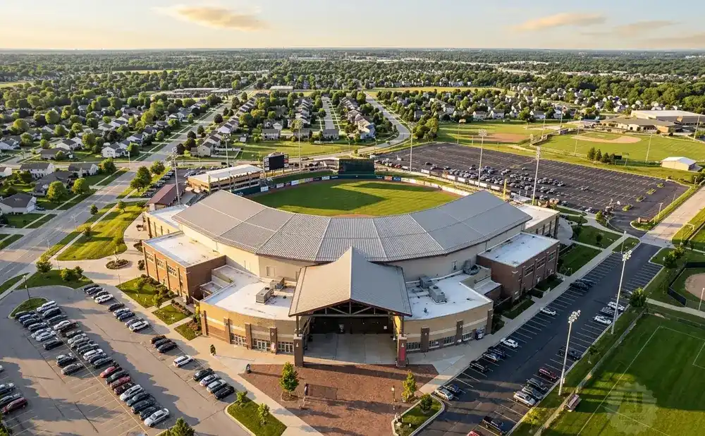 Aerial view of a baseball stadium surrounded by residential areas and parking lots.