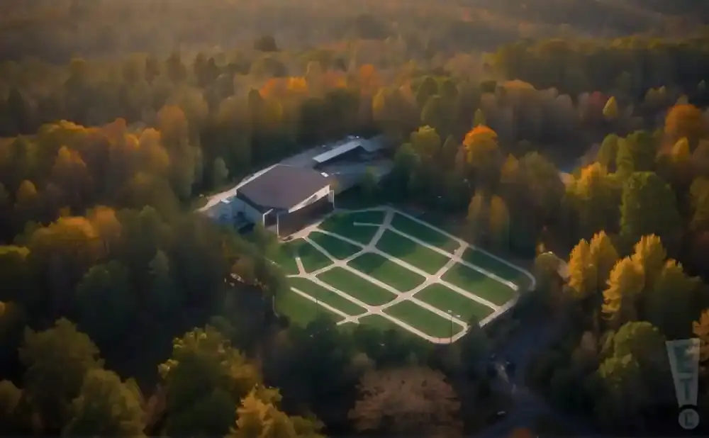 Aerial view of an outdoor amphitheater surrounded by autumn foliage.