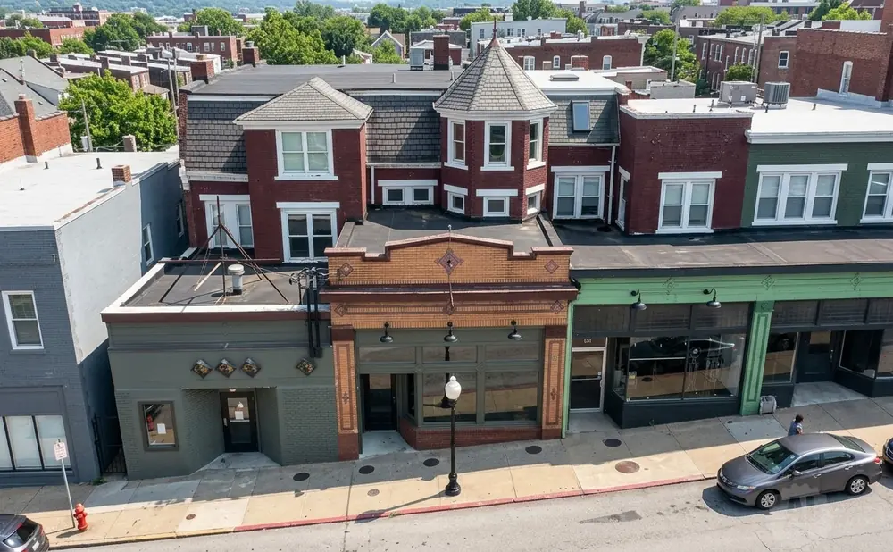 Aerial view of a brick building with businesses on the first floor and apartments above.