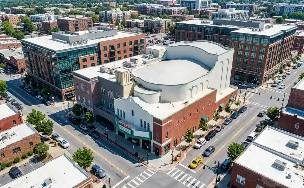 Aerial view of a city intersection with a theater and brick buildings.