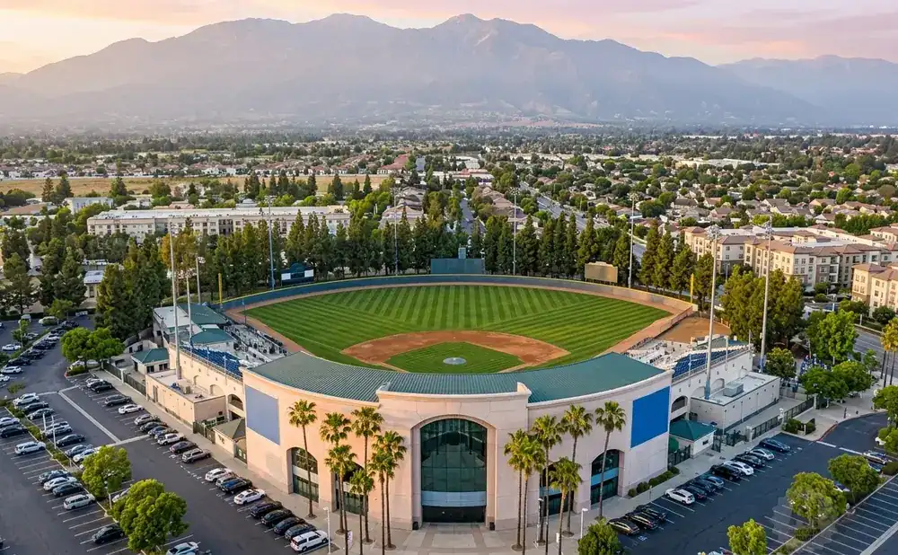 Aerial view of a baseball stadium with mountains in the background.