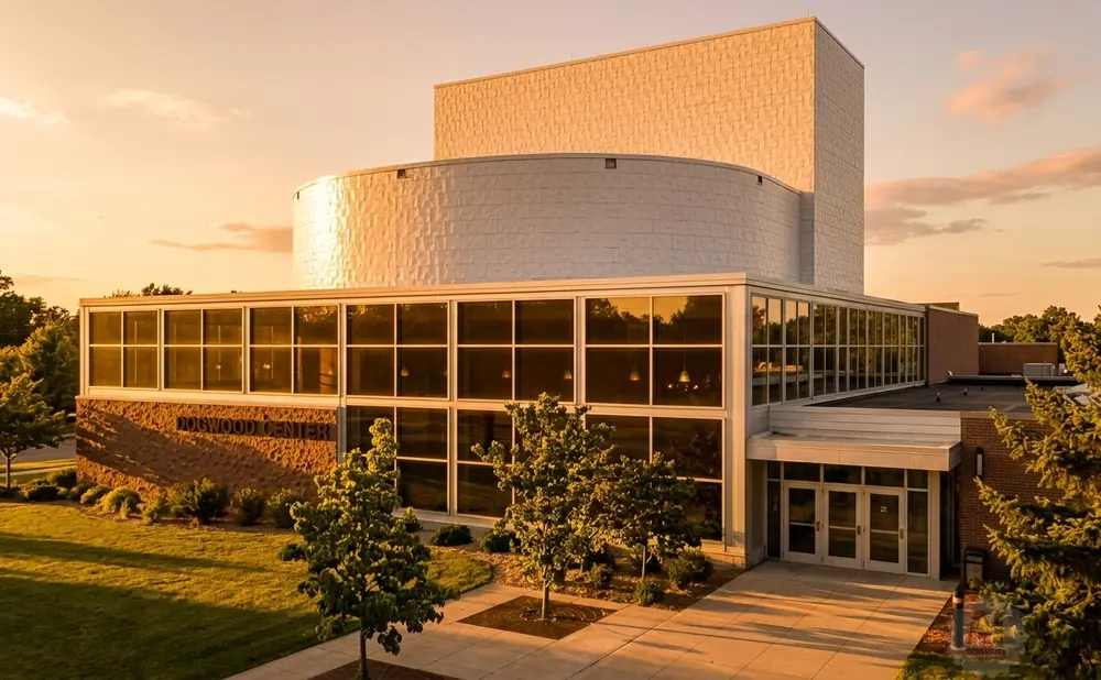 Dogwood Center at sunset, with a large curved section and a tall rectangular tower.