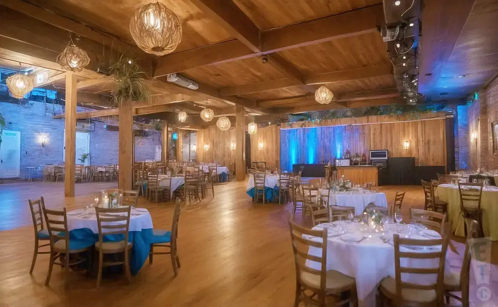 Elegant event space with wooden beams, rustic chandeliers, and round tables set for dining.
