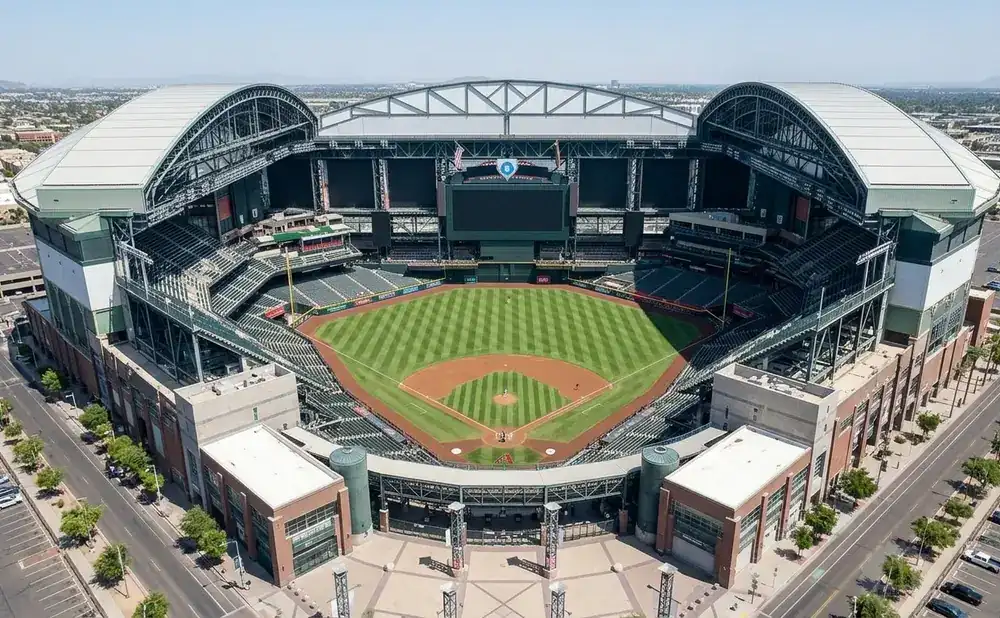 Aerial view of Chase Field, a baseball stadium with a retractable roof, green field, and surrounding urban landscape.