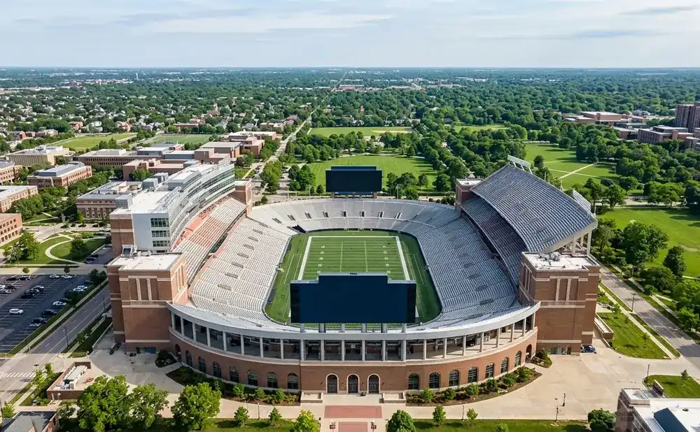 Aerial view of Memorial Stadium at the University of Nebraska–Lincoln, with a football field and surrounding campus buildings.