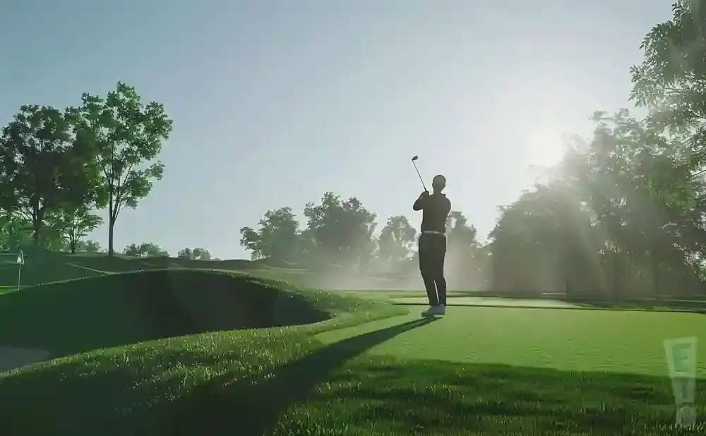 A golfer swings at a sun-drenched golf course, with trees and a hazy sky in the background.