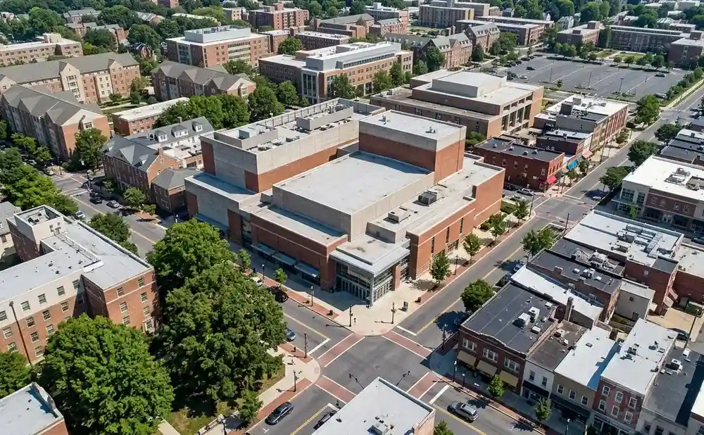 Aerial view of a university campus with brick buildings, trees, and streets.