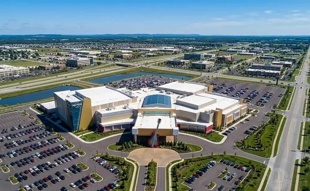 Aerial view of the Hard Rock Casino with a large guitar statue in front, surrounded by parking lots and roads.